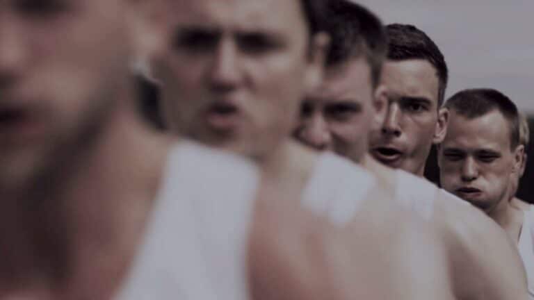 A close-up line of rowers rowing in unison during a race or training session.